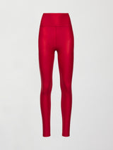 Model wears a shiny high waisted bright red pair of leggings with a thick, flattering waistband. 