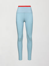 A light blue performance legging with a red waistline. 