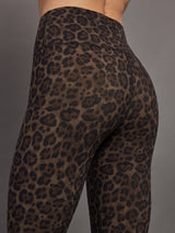 Model wears high waisted brown leopard print leggings. 