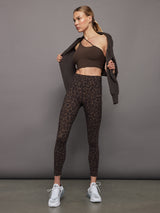 Model wears high waisted brown leopard print leggings. 