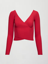 Image of a long sleeve, deep v neck top in bright red with an overlapping seam at the bottom creating the effect of a wrap top. 