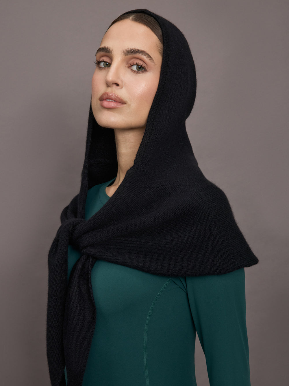 Model wears a black scarf over her head.