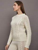 Model wearing a cream colored vertically textured wide cable knit sweater. 